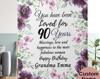 May include: A white floral patterned blanket with the text "You have been Loved for 90 Years Blessings, love and happiness to the most fabulous woman Happy Birthday Grandma Emma" and the words "Custom Name Year" at the bottom.