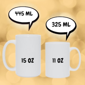 May include: Two white ceramic mugs with black text. The larger mug is 15 oz and 445 ml. The smaller mug is 11 oz and 325 ml.