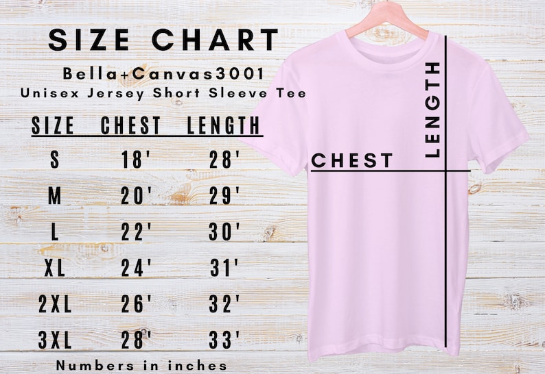 May include: A light pink Bella+Canvas 3001 unisex jersey short sleeve tee shirt hanging on a wooden hanger. A size chart shows chest and length measurements in inches: S (45.7cm chest, 71.1cm length), M (50.8cm chest, 73.7cm length), L (55.9cm chest, 76.2cm length), XL (61cm chest, 78.7cm length), 2XL (66cm chest, 81.3cm length), and 3XL (71.1cm chest, 83.8cm length).
