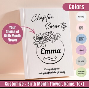 May include: A white hardback book with the words "Chapter Seventy" and the name "Emma" in elegant script. A floral design encircles the name. The text "Every chapter brings a fresh beginning" is at the bottom. The book is customizable with birth month flowers.