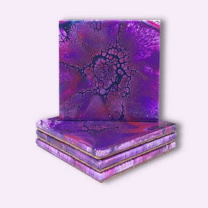 May include: Set of four purple and black abstract coasters with cork backing.