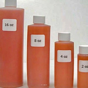 May include: Four bottles of liquid in various sizes, from 2 ounces to 16 ounces. The bottles are clear and filled with a light orange liquid. Each bottle has a white label with the size printed in black.