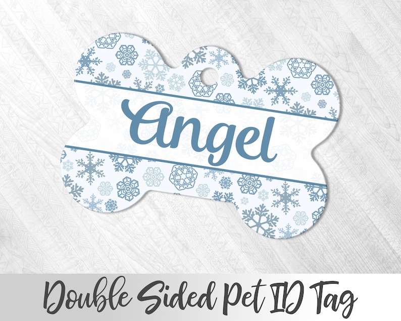 May include: White bone-shaped pet ID tag with a blue snowflake pattern and the name "Angel" printed in blue cursive lettering.  Double Sided Pet ID Tag.
