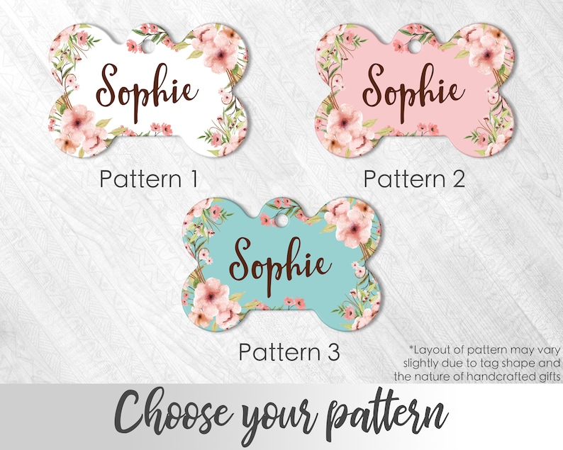 May include: Three dog tag designs with a floral pattern and the name "Sophie" on each. The tags are bone-shaped and come in white, pink, and blue.