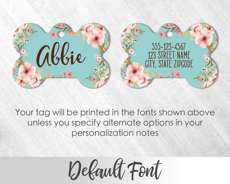 May include: A turquoise blue bone-shaped dog tag with a pink floral design. The tag is personalized with the name "Abbie" and includes space for a phone number, street address, city, state, and zip code.