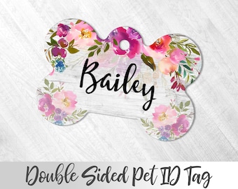 May include: Double-sided bone-shaped pet ID tag with a floral design and the name "Bailey" printed in black on a white background.