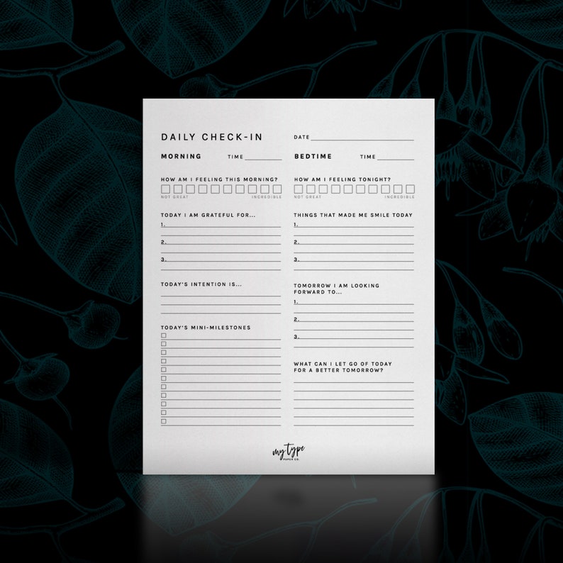 May include: A printable daily check-in sheet with sections for morning and bedtime. The sheet includes prompts for gratitude, intentions, mini-milestones, and things that made you smile. The text "DAILY CHECK-IN" is at the top of the sheet.
