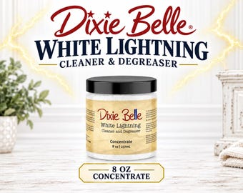 May include: A cylindrical container of Dixie Belle White Lightning Cleaner & Degreaser concentrate. The label features the product name and the text 8 oz | 237mL. The container has a black screw-top lid and contains a white granular substance.