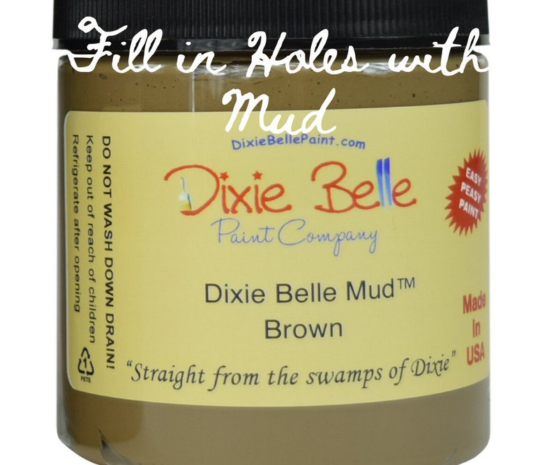 May include: A brown jar of Dixie Belle Mud&trade; paint, labeled "Fill in Holes with Mud". The jar is labeled "Dixie Belle Mud&trade; Brown" and "Straight from the swamps of Dixie".