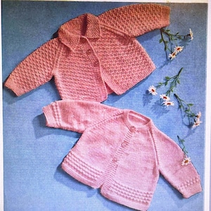 May include: Two pink knitted baby cardigans with button closures. The cardigan on the top has a collar and the cardigan on the bottom has a round neckline.