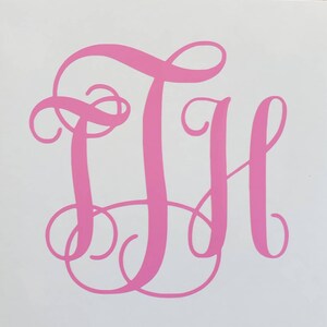 May include: Pink monogram with the letters "DH" in a cursive script font.