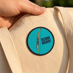 May include: A circular embroidered patch featuring a teal background with a yellow and red recurve bow illustration and the black text RECURVE ARCHERY. The patch is attached to a beige canvas fabric surface.