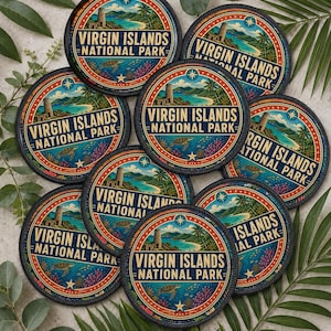May include: A collection of circular embroidered patches featuring a colorful illustration of the Virgin Islands National Park. Each patch displays a coastal landscape with a stone tower, a sea turtle, coral reefs, and the text Virgin Islands National Park.