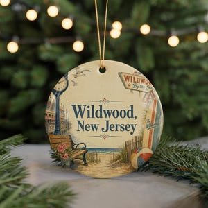 A round ornament with a beach scene and a bench, featuring the text "Wildwood, New Jersey" and a sign that says "Wildwood By the Sea".