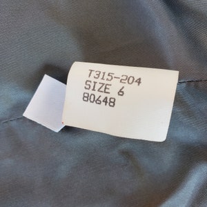 May include: White tag with black text that reads "T315-204 SIZE 6 80648".