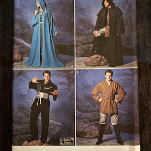 May include: Simplicity sewing pattern 5840 featuring costume designs. The pattern includes options for hooded robes, tunics, and pants. The cover displays images of the finished garments in various colors and styles. The pattern is sized XS-XL.
