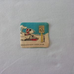1958 Peanuts Iron-On Patch-Snoopy on Sled Next to a Speed Limit Sign