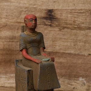 statue of Egyptian art Seated statue of Imhotep holding an open papyrus scroll 2 style stone made in egypt