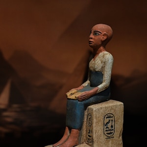Unique statue of Egyptian art Seated statue of Imhotep holding an open papyrus scroll stone made in egypt