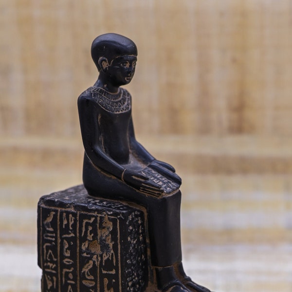 statue of Egyptian art Seated statue of Imhotep holding an open papyrus scroll stone made in egypt