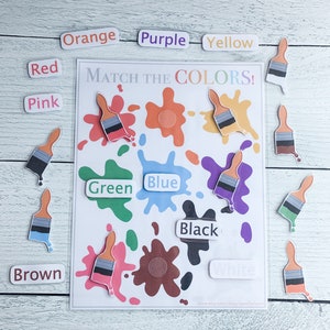 May include: A color matching game for kids featuring paintbrushes and paint splatters in various colors. The game includes the words: "Match the Colors!" "Orange", "Purple", "Yellow", "Red", "Pink", "Brown", "Green", "Blue", "Black", and "White".