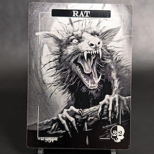May include: A black and white illustration of a rat with sharp teeth and claws. The image is on a silver background with the word "RAT" in black text at the top. The artist's signature is in the bottom left corner.
