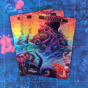 May include: A set of three fantasy trading cards featuring a colorful illustration of a tentacled creature emerging from the ocean. The card reads "TENTACLE" and has a number "11" in the bottom right corner.