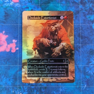 May include: A collectible card depicting the "Dockside Extortionist," a Goblin Pirate character. The card features a vibrant illustration of the character in a red coat. Text on the card details its abilities. The card is set against a blue and green patterned background.