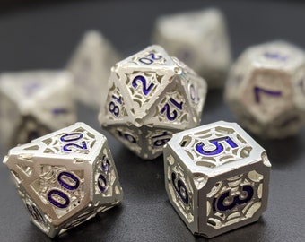 May include: A set of six silver metal dice with blue numbers. The dice have a decorative, intricate design.