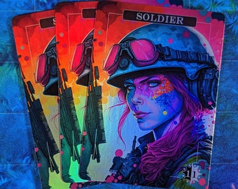 May include: Four holographic playing cards with a colorful illustration of a female soldier wearing a helmet and goggles. The card on top reads "SOLDIER" and has the number "11" in the bottom right corner.