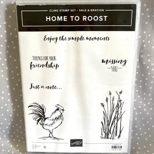May include: Clear plastic case containing a cling stamp set. The set includes stamps with text like "Home to Roost", "Enjoy the simple moments", and "Thanks for your friendship". Also includes a rooster and grass illustrations.