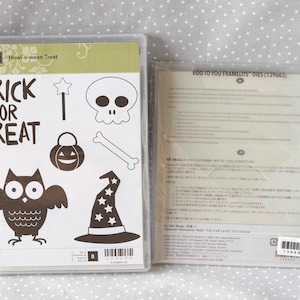 May include: Two clear plastic packages. One contains a stamp set with Halloween-themed images and the text "TRICK OR TREAT". The other package contains Framelits dies with the text "BOO TO YOU".