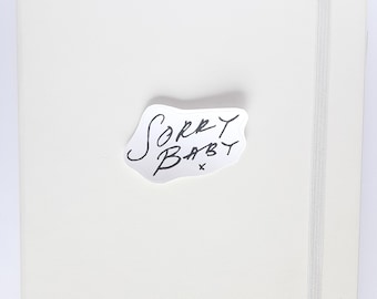 Sorry Baby. Clear/ Water-resistant/ Matte white/ Sticker.