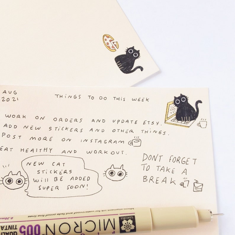 May include: Handwritten to-do list with a cat theme. The list includes tasks like working on orders, adding new stickers, posting on Instagram, eating healthy, and working out. It also includes a reminder to take a break. The list is decorated with cute cat illustrations.