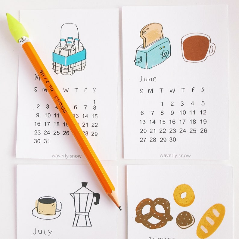 May include: Four illustrated calendar cards with a different theme for each month. June features a toaster and a cup of coffee, July features a coffee pot and a cup of coffee, August features a pretzel, a bagel, and a loaf of bread, and May features a six-pack of beverages.