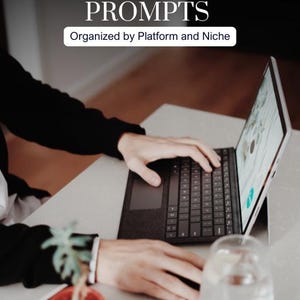 Puede incluir: Una persona usando una computadora portátil con el texto "VIRAL SOCIAL MEDIA 500+ CAPTION PROMPTS" en la pantalla. La computadora portátil está sobre un escritorio blanco, con una pequeña planta en una maceta roja, un vaso de agua y un cuaderno. El texto "Organized by Platform and Niche" también es visible.