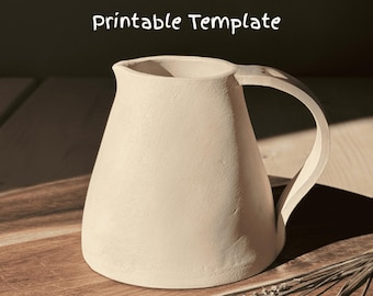 May include: A white ceramic pitcher with a rounded body and a handle. The pitcher is sitting on a wooden surface.