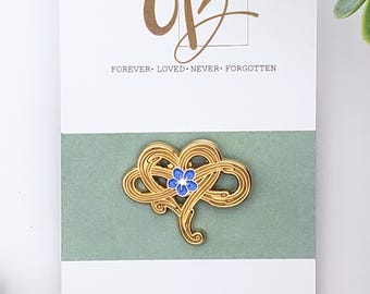 Pin conmemorativo por la pérdida de un ser querido