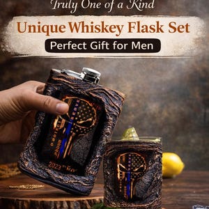 May include: A unique whiskey flask set with a textured, dark brown finish. The flask and glass feature a skull design with a blue line and the words "PROTECT, PROUD, SERVE". The set is handcrafted by one artisan.