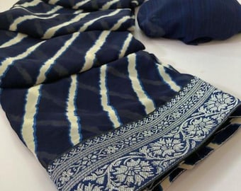 May include: A navy blue and cream-colored fabric with a striped pattern. The fabric has a detailed silver floral border. A matching navy blue fabric is also present.