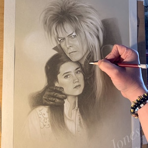 May include: A black and white pencil drawing of a man and a woman. The man has long, white hair and is wearing a dark shirt. The woman has long, dark hair and is wearing a white shirt. The man's hand is resting on the woman's shoulder.