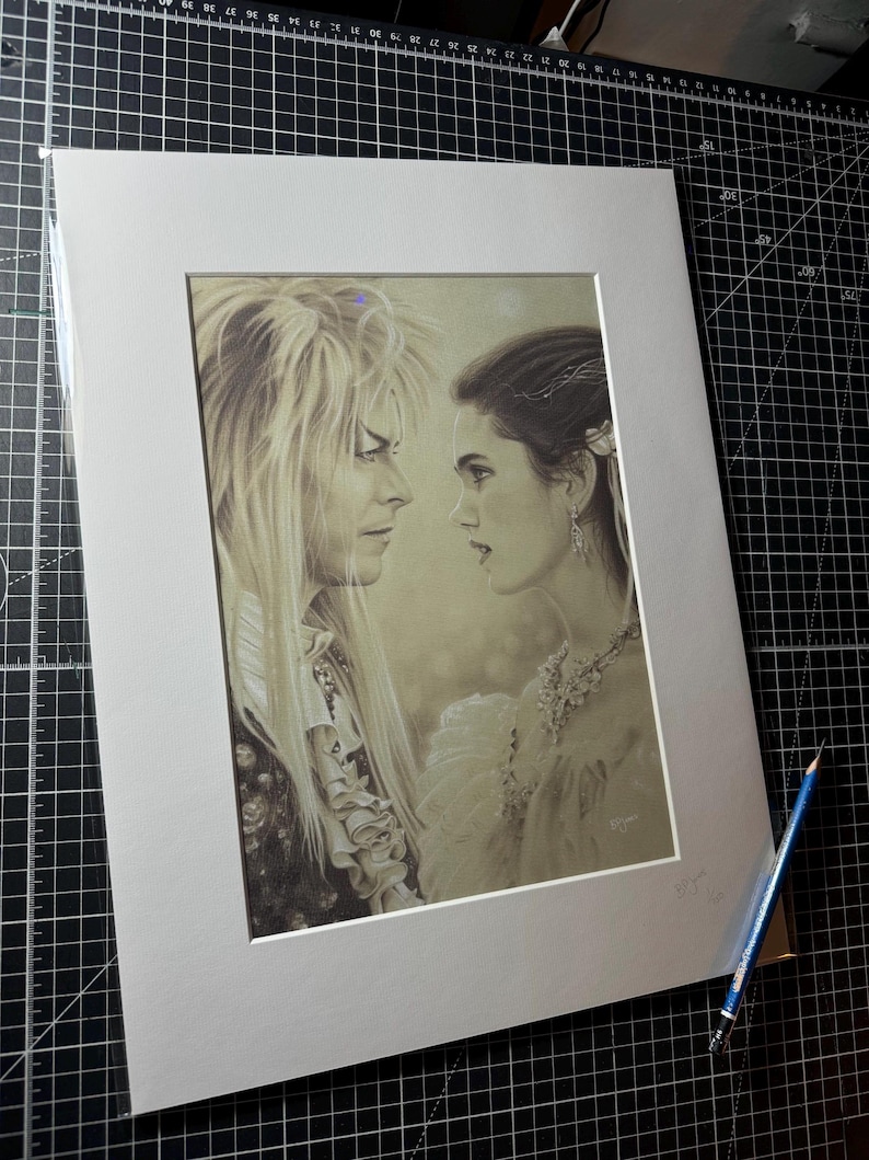 May include: A black and white illustration of a man and woman looking at each other. The man has long, flowing hair and is wearing a dark suit. The woman has long, dark hair and is wearing a white dress. The background is a soft, blurred image of a forest.