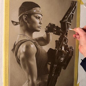 May include: A sepia-toned drawing of a person in a bandana, holding a large weapon. The weapon has the word "ADIOS" on it. The artist's signature "Barry Jones" is visible. The drawing is taped to a white surface.