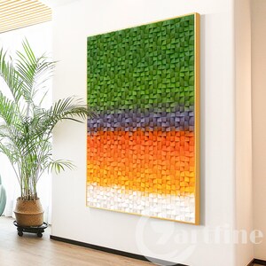 May include: Abstract wall art featuring a geometric pattern of green, purple, orange, and white squares. The squares are arranged in horizontal bands, creating a gradient effect.