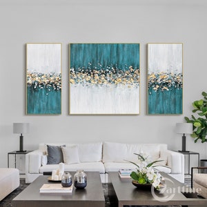 Teal and gold framed wall art featuring abstract floral patterns.