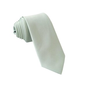 May include: A light green silk necktie, folded and ready to wear.