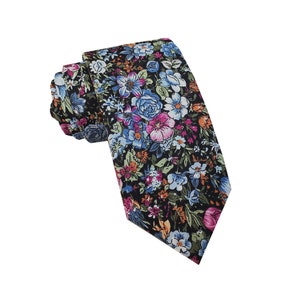May include: A necktie featuring a black background with a dense, colourful floral pattern. The design includes various flowers in shades of light blue, pink, white, and orange, interspersed with green leaves, creating a vibrant and detailed botanical print.