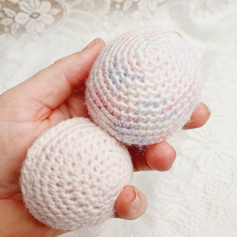 Handknitted wool ball rattles.