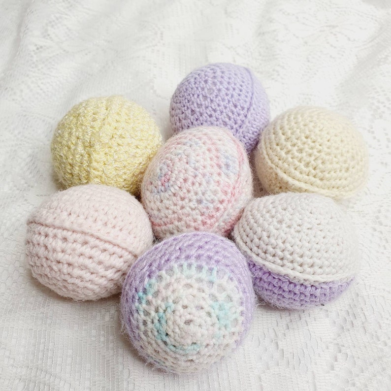 Handknitted wool ball rattles.