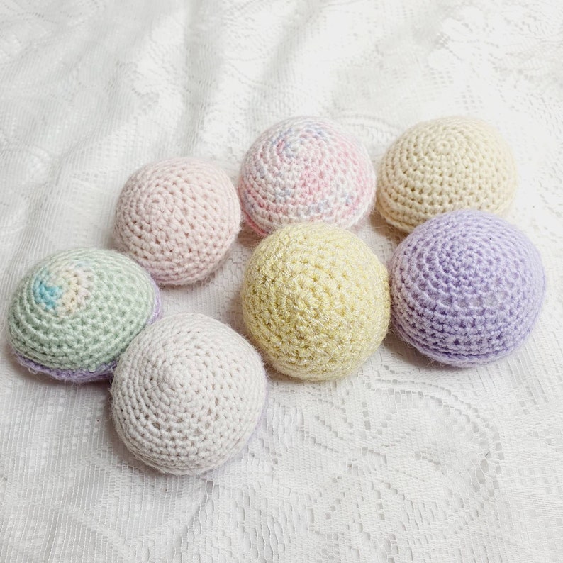 Handknitted wool ball rattles.